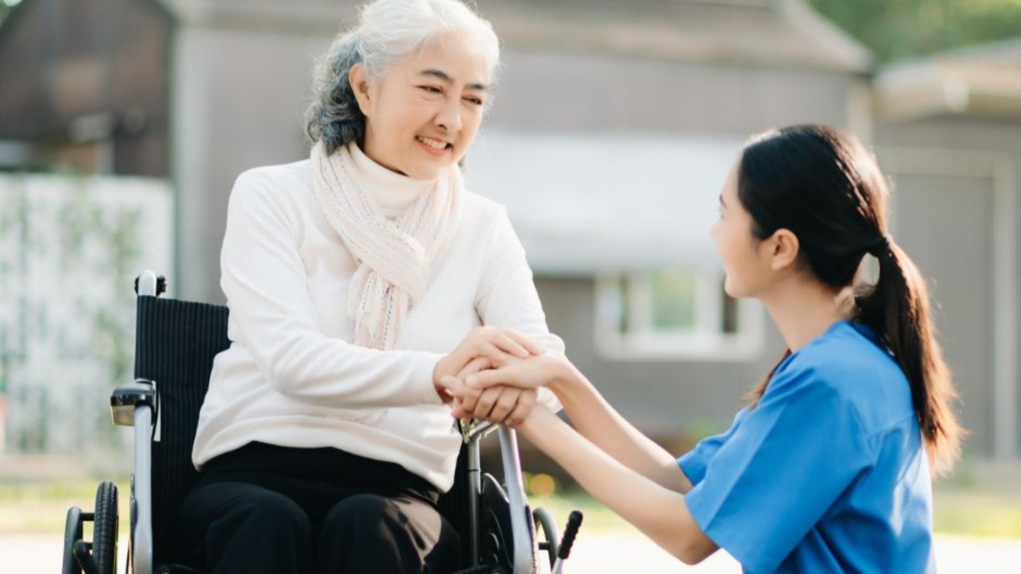 Caregiver providing home care services to elderly woman in wheelchair in Fort Washington MD