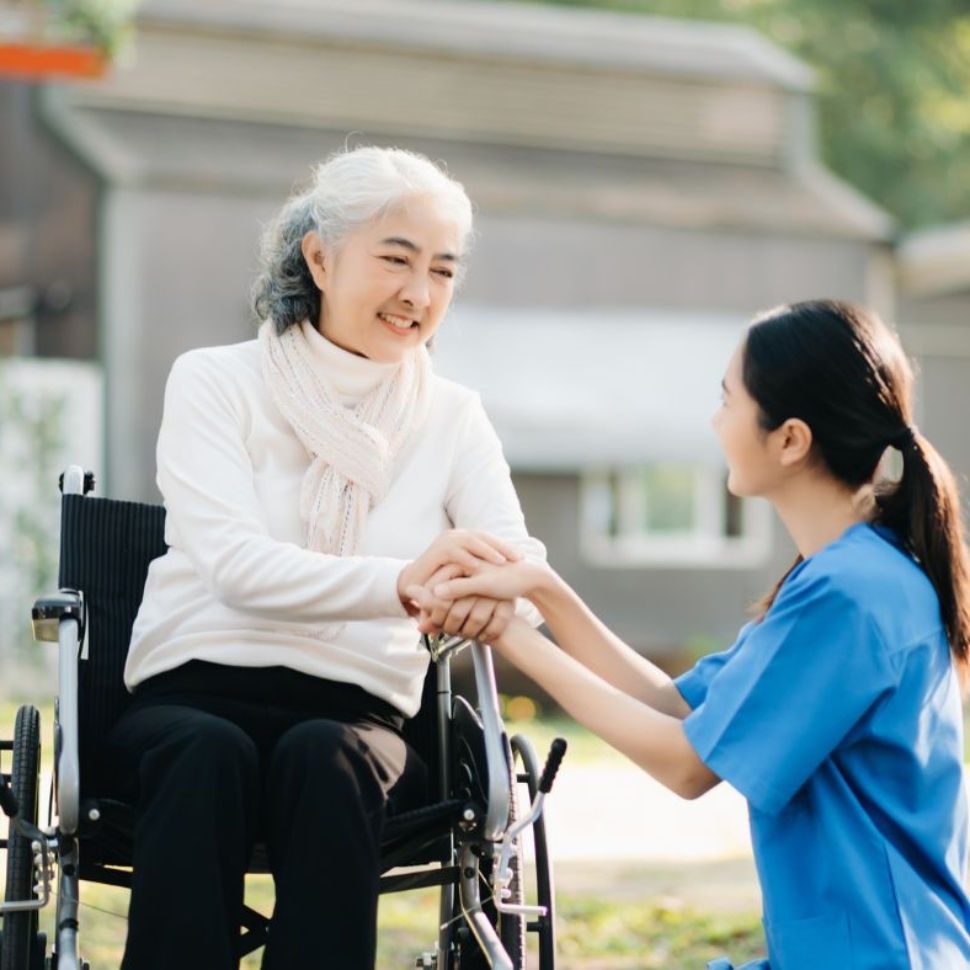 Caregiver providing home care services to elderly woman in wheelchair in Fort Washington MD